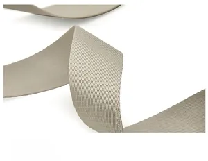 Detailed close-up of a soft beige nylon shoulder strap with a twill weave texture