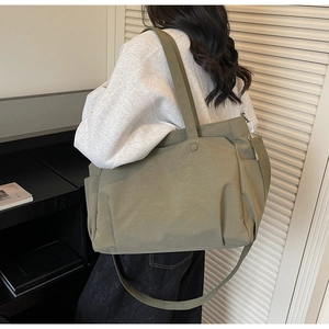 Detail view of large capacity oxford tote bag with side pocket and adjustable strap