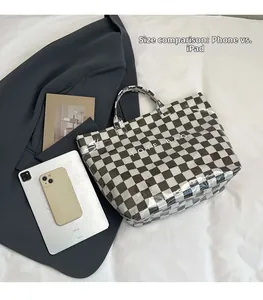 Checkerboard tote bag size comparison with tablet and phone for capacity display