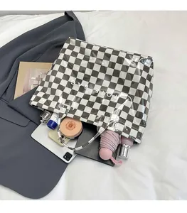 Top view of a large checkerboard tote bag showing spacious interior with daily essentials