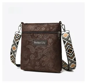 Detail of vintage brown paisley floral crossbody bag with ethnic jacquard strap