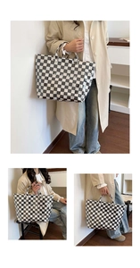 Close-up of black and white checkered tote bag with white TOTE BAG lettering and handles
