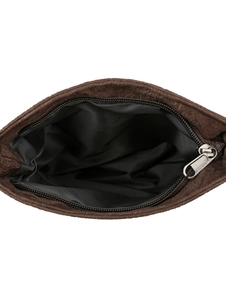 Detail view of the soft brown suede bag interior with black lining and silver zipper