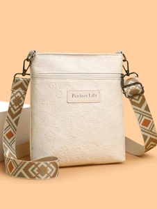 Cream paisley embossed crossbody bag with ethnic embroidered wide shoulder strap