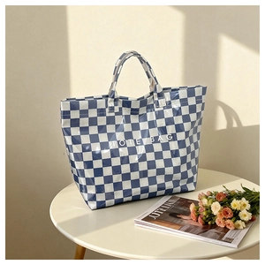 Detailed view of checkered tote bag featuring white VOTE BAG text on blue and white pattern