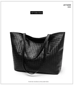 Detail of a large black woven tote bag shown from a 45-degree angle with dual handles
