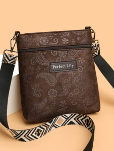 Detailed paisley embossing on dark brown leather crossbody bag with wide ethnic strap