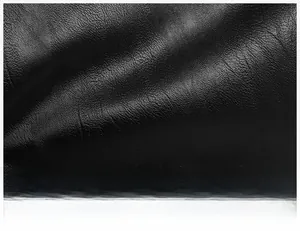 Close-up of premium black leather material with fine lychee grain and matte finish