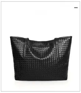 Detailed reverse side view of the black woven leather tote bag with double handles