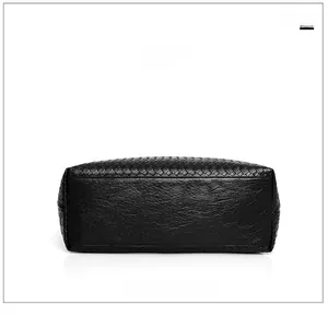 Detailed bottom view of black woven tote bag with premium pebbled leather texture