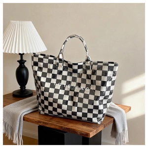 Macro shot of checkered tote bag glossy texture and TOTE BAG lettering detail