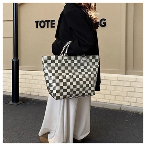 Detail of olive green and white checkerboard tote bag with high-gloss PVC finish
