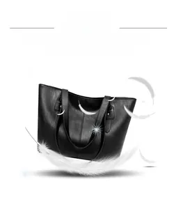 Close-up of black leather tote bag with lightweight material and reinforced shoulder straps
