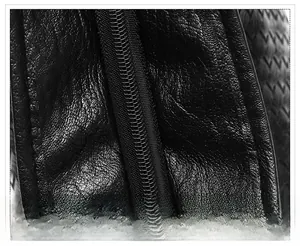 Close-up of smooth black zipper on high-quality lychee texture leather tote bag