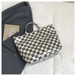 Macro detail of checkered tote bag with high-gloss finish and TOTE BAG lettering