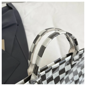 Detailed shot of the checkerboard tote bag with glossy waterproof coating and sturdy handles