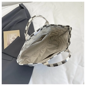Top view of checkerboard tote bag interior with zipper pocket and gray lining detail