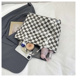 Interior view showing large capacity of checkerboard tote bag with daily essentials