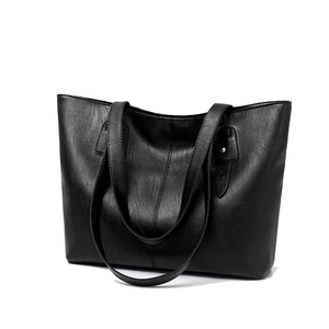 Classic large black leather tote bag with double handles shown from a 45-degree angle