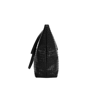 Minimalist black woven tote bag with spacious design and textured leather side view