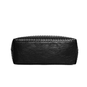 Black woven tote bag with durable lychee textured bottom on white background