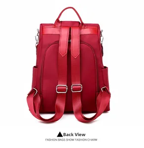 Detailed back view of a red oxford backpack showing the anti-theft zipper and straps