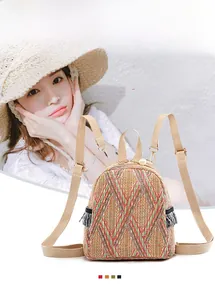 Detail view of ivory woven backpack with colorful stripes and decorative pearl handle