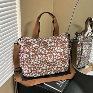 Floral print tote bag in brown with adjustable shoulder straps and side pockets