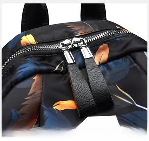 Detail of high-quality leather pullers and smooth metal zippers on printed backpack