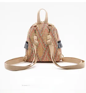 Detail view of woven backpack featuring geometric patterns and stylish blue-white tassels