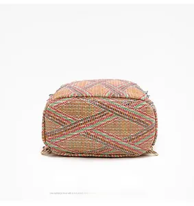 Detailed macro view showing the woven texture and reinforced bottom of the colorful straw bag