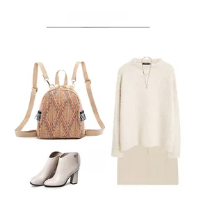 Flat lay of mini woven backpack styled with cream ankle boots and knit sweater outfit