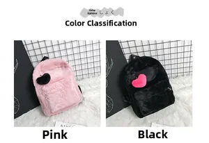 Detail of plush backpacks in pink and black featuring contrast heart-shaped fuzzy charms