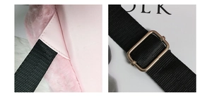 Detail of pink plush fabric, synthetic leather stitching and adjustable metal strap buckle