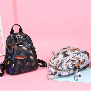 Women's lightweight printed nylon backpacks in black feather and grey butterfly designs