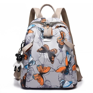 Lightweight grey nylon backpack with butterfly print and teddy bear pendant