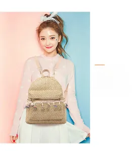 Detail of bohemian straw backpack with colorful tassels and pearl charms on model