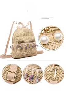 Detail of straw backpack with colorful tassels, pearl zippers and metal buckles