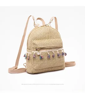 Detail view of straw woven mini backpack with white pearls and colorful tassels trim