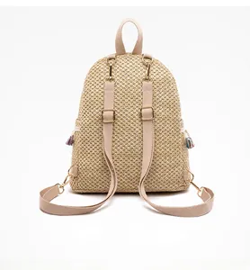 Detailed back view of a straw backpack with adjustable straps and metal buckles