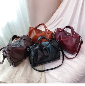 Classic Boston handbags in four retro colors with metallic stud details and shoulder straps