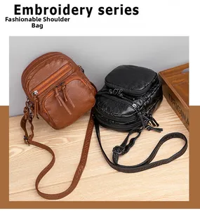 Detail view of multi-layer soft leather crossbody bags in brown and black colors