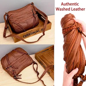 Brown soft faux leather crossbody bag with three zipper pockets and woven detail