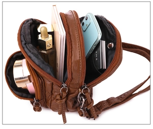 Top-down view of a multi-layer brown PU leather crossbody bag showing spacious interior