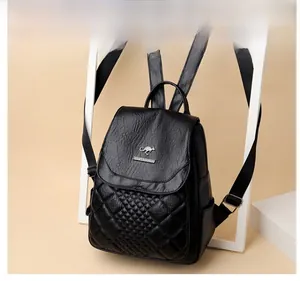 Detailed view of black PU leather backpack featuring quilted pattern and metal logo