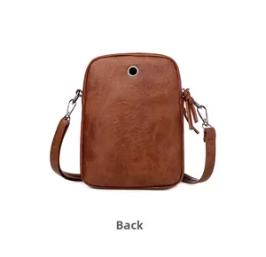 Back view of brown faux leather crossbody phone bag with earphone hole and zipper detail