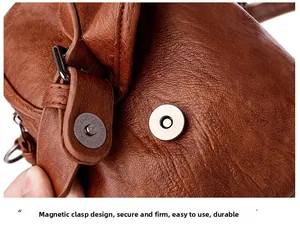 Detailed close-up of brown litchi pattern leather bag with a silver magnetic buckle