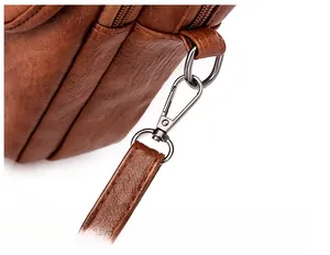 Detail of brown litchi pattern leather bag with durable detachable metal hardware hook
