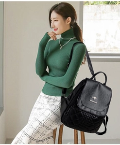 Black leather quilted backpack with a kangaroo emblem worn by a female model