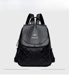 Detail view of the black quilted faux leather backpack with silver kangaroo logo plaque